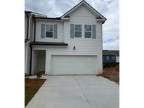 Charming two-story home with a two-car garage, white siding, gray shutters, and concrete driveway at 1031 Merritt Dr # 96, Villa Rica, GA 30180