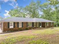 Charming brick home with black shutters, a covered entry, and a lush green lawn at 9 Latimer Rd, Cartersville, GA 30121