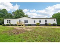 Charming single-story home with white siding and a well-maintained front yard at 1960 W Hightower Trl, Conyers, GA 30012