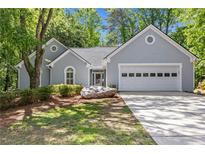 Charming one-story home with a two-car garage, inviting curb appeal, and well-maintained landscaping at 1965 Tiner Ct, Cumming, GA 30041
