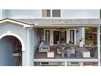 A beautiful outdoor deck with a ceiling fan, comfortable seating, and a view of the surrounding greenery at 1420 Cortez Ne Ln, Atlanta, GA 30319