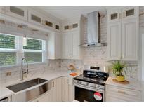 Bright kitchen features white cabinetry, stainless steel appliances, and a modern design at 1095 Lyndhurst Way, Roswell, GA 30075