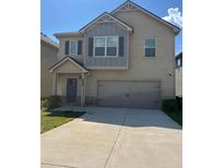 Charming two-story home with a two-car garage and a well-maintained front yard at 11600 Winston Dr, Hampton, GA 30228
