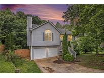 Charming split-level home with a two-car garage and freshly painted siding at 3694 Arrowhead Pl, Douglasville, GA 30135