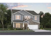 Charming two-story home featuring stone accents, gray siding, and a two-car garage, beautifully landscaped for curb appeal at 5121 Hillside Haven Dr, Powder Springs, GA 30127