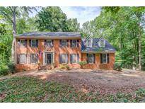 Charming two-story brick home with black shutters and a well-manicured front yard at 3741 Windhurst Dr, Lilburn, GA 30047