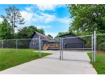 Charming gray home featuring a well-maintained lawn and secure fencing at 4131 West Village Pkwy, Ellenwood, GA 30294
