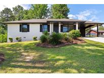 Charming brick home with a well-manicured lawn and tasteful landscaping at 10116 Straphinge Trl, Covington, GA 30014