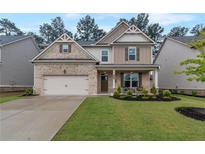 Charming two-story home with a well-manicured lawn and a two-car garage at 592 Eagles Nest Cir, Auburn, GA 30011