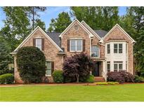 Charming brick home with lush front yard, manicured landscaping, and traditional architectural details at 2759 Thomashire Trce, Marietta, GA 30066