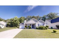 Charming single-story home featuring a well-manicured front yard, a concrete driveway, and a cozy, inviting entrance at 4954 River Overlook Way, Lithonia, GA 30038