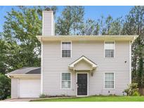 Charming two-story home with neutral siding, manicured lawn, and attached garage at 5229 Kirk Dr, Atlanta, GA 30349
