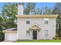 Charming two-story home featuring a classic design and a well-maintained front yard at 5229 Kirk Dr, Atlanta, GA 30349