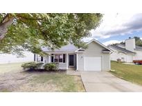 Charming single-story home with gray siding, attached garage, and a well-maintained front yard at 6614 Biscayne Blvd, Rex, GA 30273