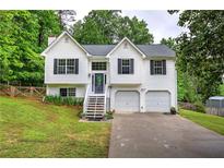 Charming two-story home with a well-manicured lawn and two-car garage at 70 Ashbury Ct, Dallas, GA 30157