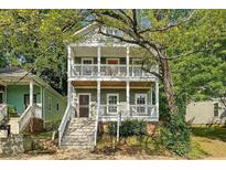 Charming two-story home with dual front porches surrounded by lush trees at 737 Cooper Sw St, Atlanta, GA 30315