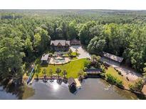 Stunning aerial view of lakefront home featuring a private pool, expansive yard, and dock at 4095 E Highway 166 Hwy, Carrollton, GA 30116