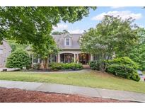 Charming two-story home with brick facade, manicured landscaping, and inviting front porch at 4842 Registry Nw Dr, Kennesaw, GA 30152