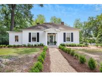 Charming single-story home with a landscaped yard and a welcoming front entrance at 95 Whitlock Sw Ave, Marietta, GA 30064