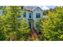 Charming white townhouse with well-manicured landscaping and a welcoming brick staircase leading to the front door at 219 Phillips Ln, Alpharetta, GA 30009