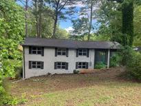 Two story exterior home with black shutters and lush surrounding landscaping providing curb appeal at 2851 Headland Dr, East Point, GA 30344