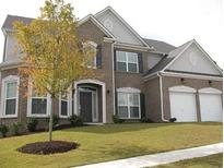 Charming two-story brick home with a well-manicured lawn and attached two-car garage at 947 Simonton View Ln, Lawrenceville, GA 30045
