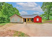 Charming single-story home featuring a mix of siding and brick, complemented by a spacious driveway at 126 Usher Ln, Covington, GA 30016