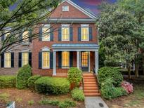 Charming two-story brick home with manicured landscaping and a welcoming front porch and entry at 5000 Davenport Pl, Roswell, GA 30075