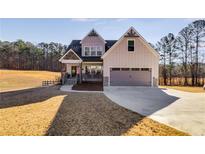 Charming two-story home with a manicured lawn, covered porch and attached two car garage at 1721 Mcgarity Rd, Temple, GA 30179