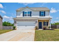 Charming two-story home featuring a two-car garage, brick accents, and a well-manicured lawn at 180 Oliver Dr, Locust Grove, GA 30248