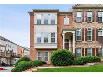 Charming brick townhome with manicured front yard and covered entrance at 2149 Shoop Se Ct # 3, Smyrna, GA 30080