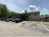 Apartment building featuring ample parking space in the front, with lush green trees in the background at 607 Park Ridge Cir, Marietta, GA 30068