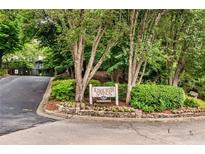 Community entrance sign surrounded by mature landscaping and flowers at 318 Tuxworth Cir, Decatur, GA 30033