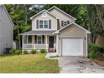 Charming two-story home with a covered front porch and a one car attached garage at 429 Orchard Dr, Stone Mountain, GA 30083