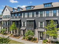 Modern townhome exterior showcasing gray siding, white trim, and well-manicured landscaping for curb appeal at 964 Catamaran Ct, Alpharetta, GA 30005