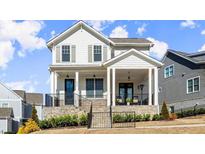 Charming two-story home with white siding, a stone foundation, and a welcoming front porch at 2005 Haley Walk, Woodstock, GA 30188