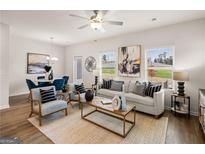 Bright and airy living room featuring modern decor, ceiling fan, and neutral color palette at 216 Eping Dr, Stockbridge, GA 30281