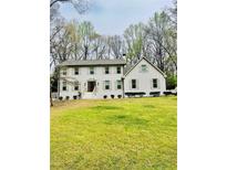Charming two-story home with a large front yard and traditional design, perfect for Gathering living at 313 Summit Ridge Dr, Lawrenceville, GA 30046