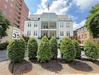 Beautiful condominium building with well-manicured landscaping and an American flag at 3655 Peachtree Ne Rd # 304, Atlanta, GA 30319