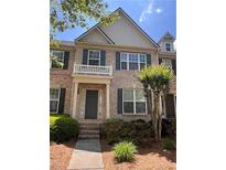 Beautiful brick townhouse with dark shutters and a charming front porch at 4540 Cold Spring Ct, Cumming, GA 30041