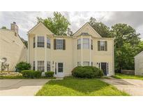 Charming two-story home with yellow siding, a well-maintained yard, and an inviting front entrance at 5680 Hampton Ct, Atlanta, GA 30349