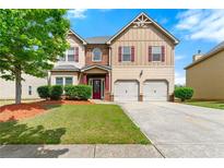Inviting two-story home with a well-maintained lawn, two car garage, and appealing curb appeal at 1892 Ivy View Walk, Loganville, GA 30052