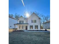 Beautiful two-story home showcasing a charming front porch and a well-manicured lawn at 3964 Riverchess Lot#157 Sw Dr, Atlanta, GA 30331