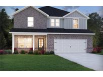 Charming two-story home features a gray brick facade, covered porch, and two-car garage at 4009 Brushy St, Powder Springs, GA 30127