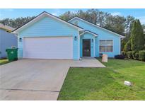 Charming single-story home with a well-maintained lawn, attached two-car garage, and light blue exterior at 4585 Post Ridge Ln, Lithonia, GA 30038