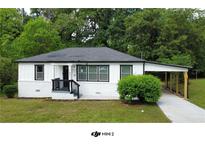 Charming single-story home with fresh white paint, black trim, and a covered carport at 1931 Selwyn Dr, Decatur, GA 30035