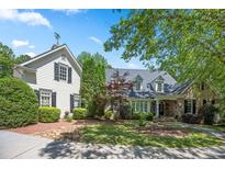 Charming home with a lush landscaped front yard and stone walkway at 240 Rose Ridge Dr, Canton, GA 30115