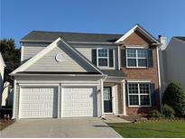 Charming two-story home featuring a two-car garage and brick accents at 8850 Grappe Trace, Suwanee, GA 30024