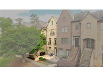 Charming townhome boasts a private patio with an outdoor seating area and well-maintained landscaping at 538 Micayne Cir # 3, Smyrna, GA 30082