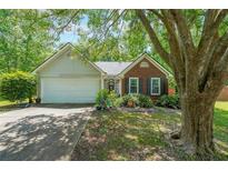 Charming single-Gathering home with brick and siding, features a well-maintained yard, and attached garage at 4872 Nature Trl, Austell, GA 30106